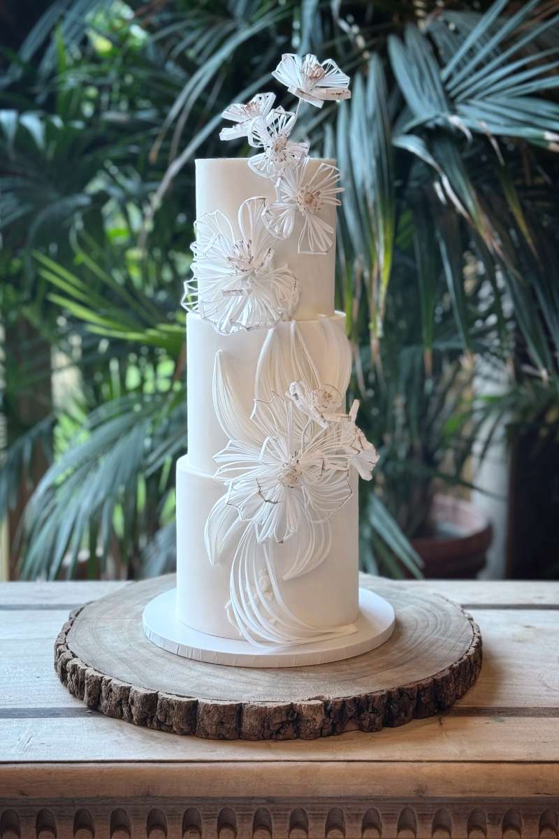 Three tier white wedding cake with modern filigree flowers, Newton Hall, Northumberland